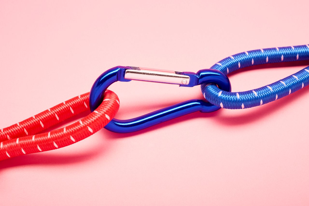 Two different colored ropes connected together with a carabiner 