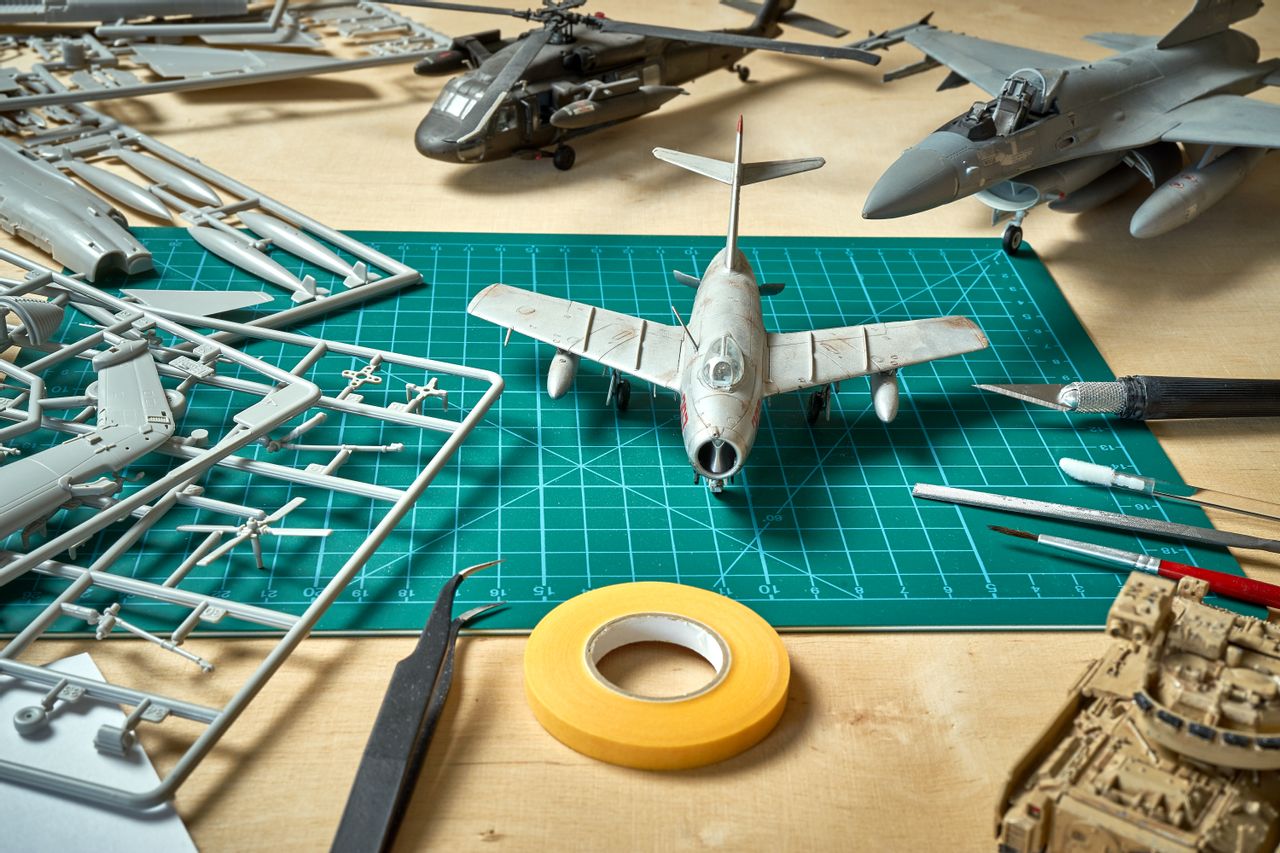 Close up of building model planes, with tools