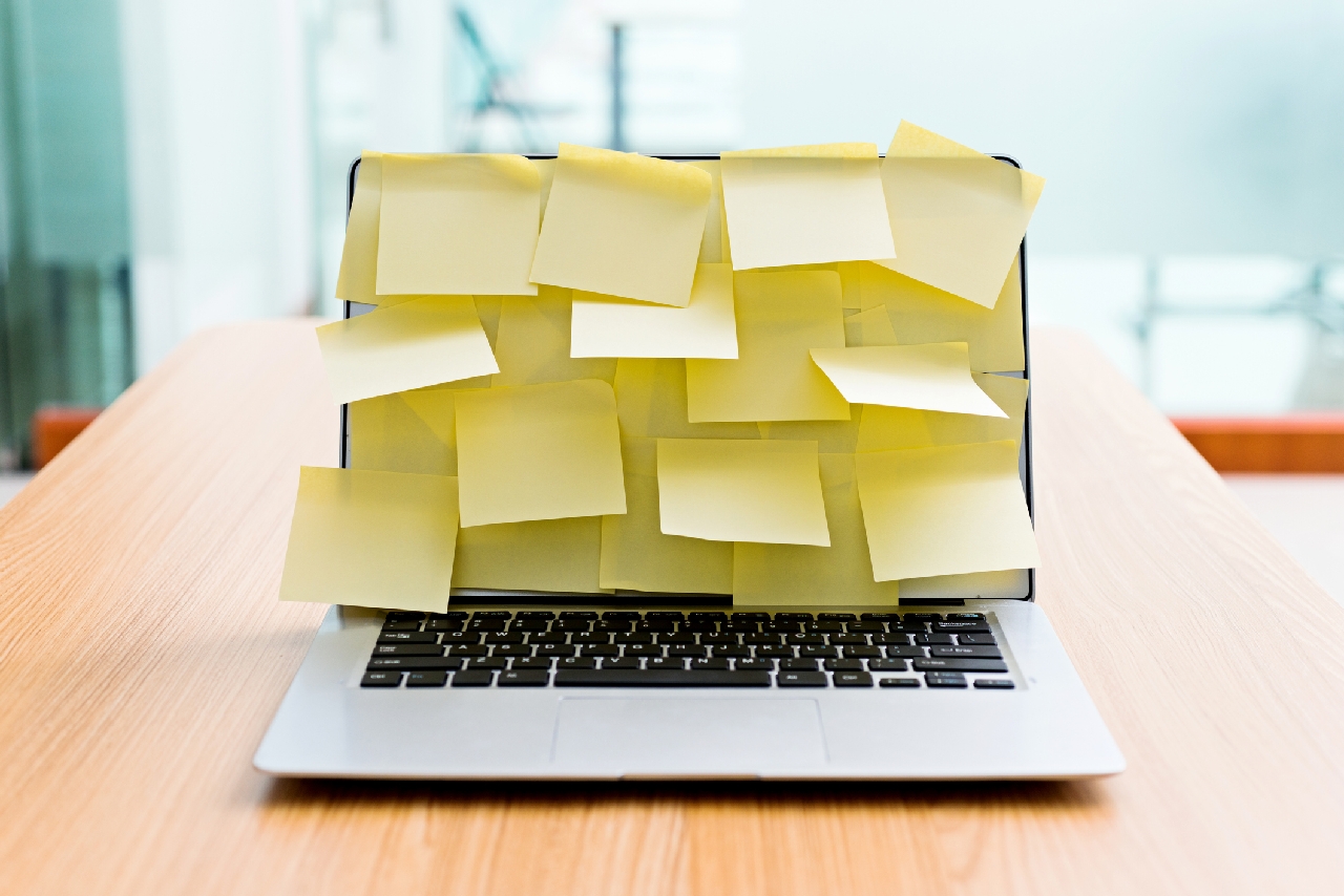 Photo of laptop screen covered with post-it notes