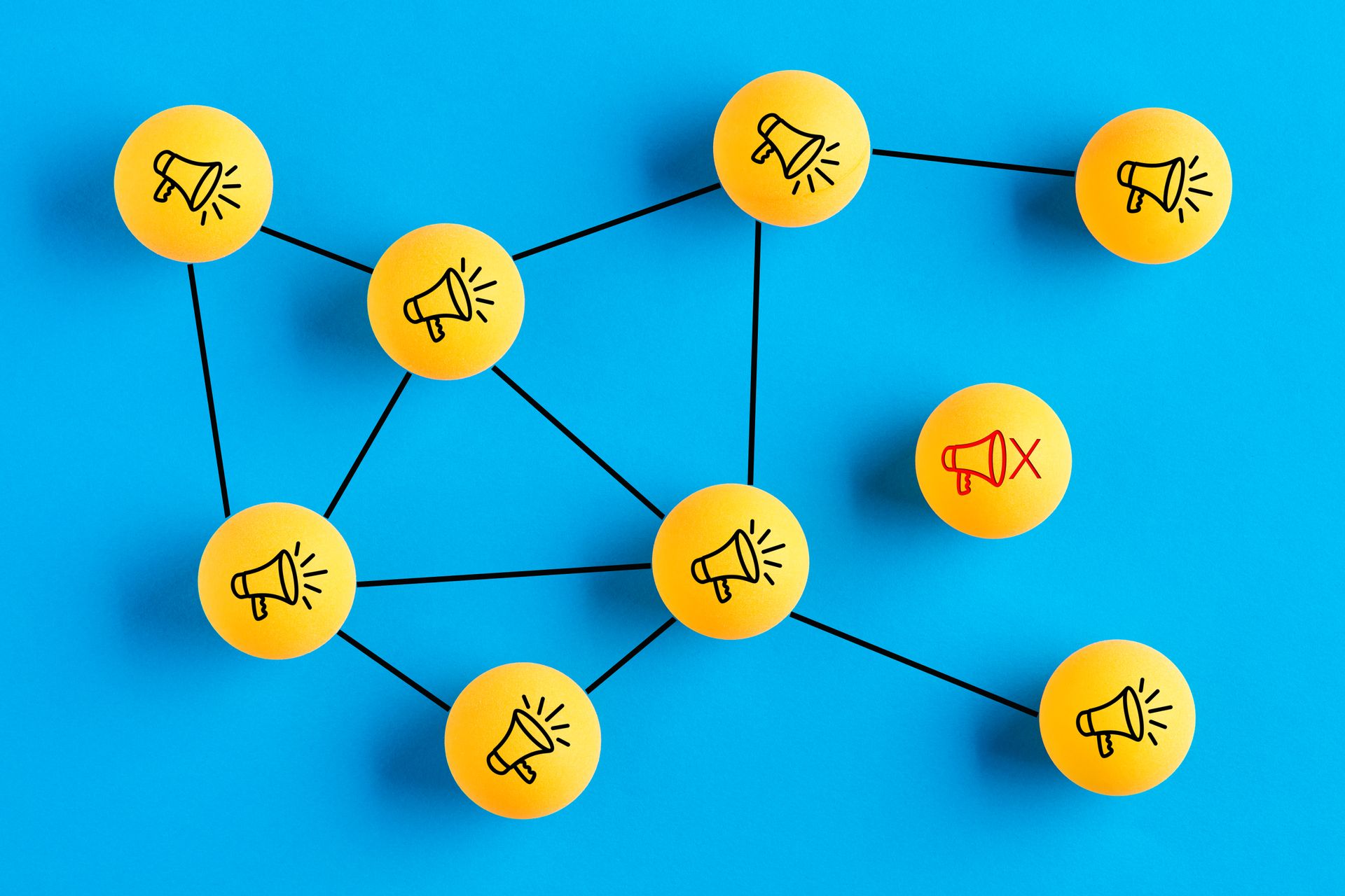 Network of yellow balls with megaphones on them, against a bright blue background