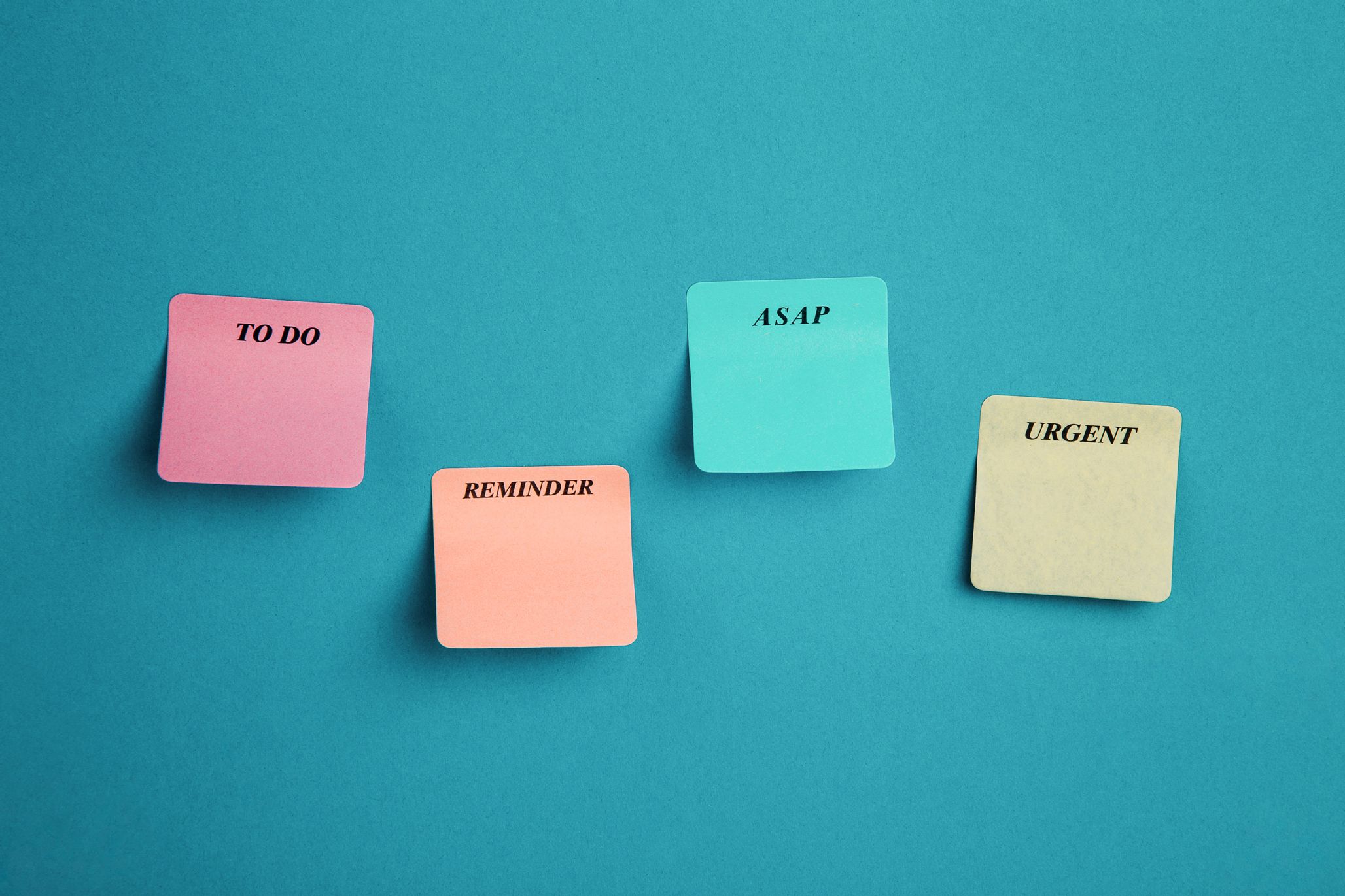 "To do" "reminder" and "ASAP" colored Post-It notes against a blue background